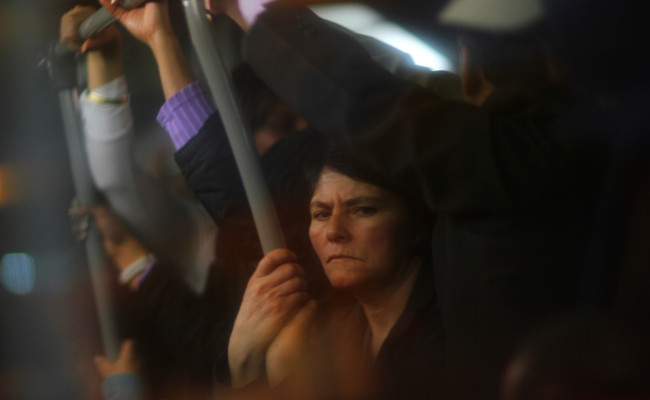 A Colombian woman rides the Transmilenio at night