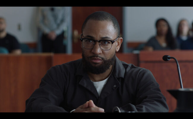 Photo 2 Lewis_is_courtroom.Still131